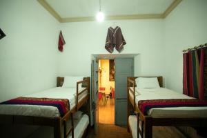 A bed or beds in a room at Hostel Cultural Pata y Perro