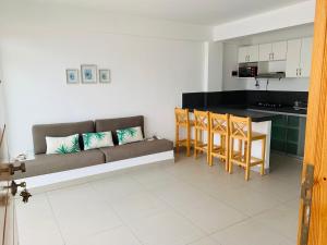 a living room with a couch and a kitchen at Apartamentos Punta Hermosa in Punta Hermosa