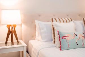 a bedroom with a bed with a lamp and a pillow at prime retreats - beach vista Emaar in Dubai +11 photos