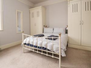 a bedroom with a white bed with a white frame at Yewdale in Lytham St Annes