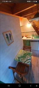 a table and a chair in a room with a sink at Sur tiny house in El Bolsón