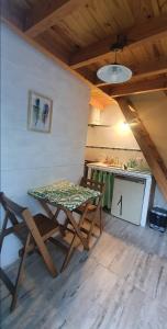 a table and chairs in a room with a kitchen at Sur tiny house in El Bolsón