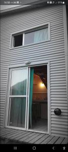 a garage door with a window in a house at Sur tiny house in El Bolsón