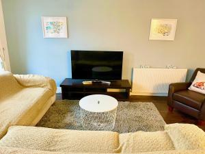 a living room with a couch and a coffee table at Entire Home between London and Kent- Mulberry House in Kent
