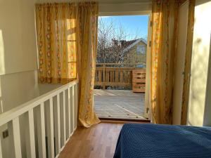 a bedroom with a door open to a deck at The Studio in Stockholm