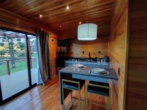 a kitchen with a table with wine glasses on it at Monte Alegre Pousada in São Joaquim