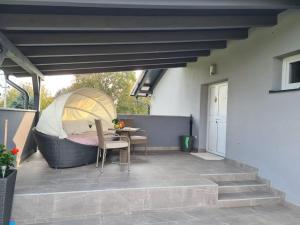 a patio with a tent and a table and chairs at Apartman PEPI in Zagreb