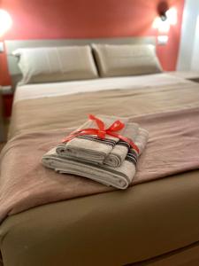a hotel room with two beds with towels and a ribbon at Dimora T'ama in San Lorenzello