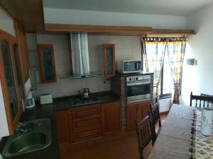 a kitchen with a sink and a microwave at Aire Serrano in Alta Gracia