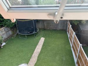 a view of a backyard with a fire pit at Beautiful 4 bedroom home 3 bathrooms, Excellent location, Family, Group, Corporate, Contractor in Thamesmead