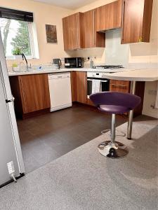 a kitchen with a purple stool in a kitchen at JOSIS Homes in Wolverhampton