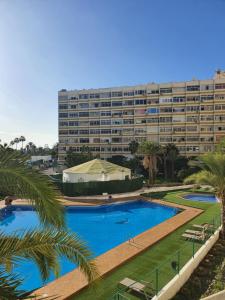 a large apartment building with a large swimming pool at Playa del Ingles Estudio LOS MOLINOS 205 in Maspalomas
