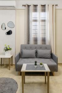 a living room with a couch and a table at PEARL STUDIO free private parking in Thessaloniki