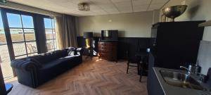 a living room with a couch and a table at Sientjes Boetiekhotel in Kerkdriel