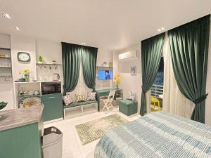 a bedroom with green curtains and a bed and a desk at Luxury Studio House 589-1 in 6th Of October