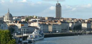 a view of a city with a ship in the water at Quiet & Cosy near Loire River & Tramway in Nantes
