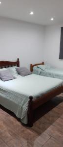 two beds sitting next to each other in a room at Casa vacaciones Camet Norte in Camet Norte