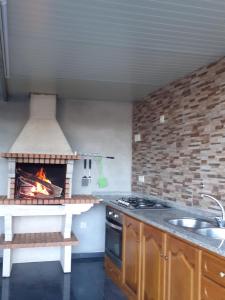 a kitchen with a stove and a fire oven at Casa dos Mirandas in Vieira do Minho