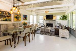 a living room with a dining table and a fireplace at Happiness Ranch - Pecan Tree House in Blanco