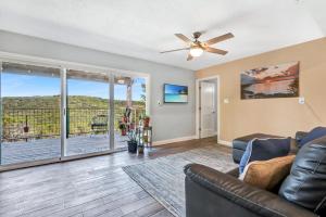 a living room with a couch and a ceiling fan at Painted Paradise Guest Suite in New Braunfels