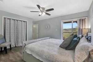 a bedroom with a bed with a ceiling fan and a window at Painted Paradise Guest Suite in New Braunfels +25 photos