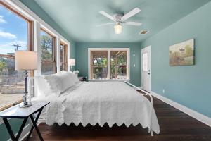 a bedroom with a bed and a ceiling fan at Milk Bath Springs House in Dripping Springs