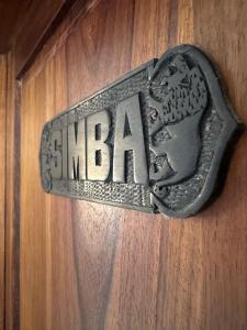 a metal sign on a wooden wall with the word shiba at Blue Villa Zanzibar in Pwani Mchangani