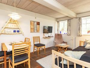 a living room with a bed and a dining room at 4 person holiday home in Faaborg-By Traum in Bøjden