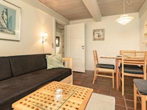 a living room with a couch and a table at 4 person holiday home in Faaborg-By Traum in Bøjden