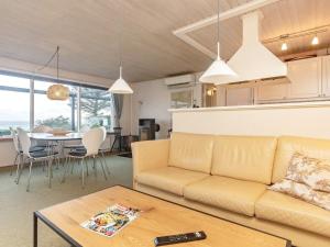a living room with a couch and a table at Beachfront Family Retreat - By Traum Ferienwohnungen in Næs