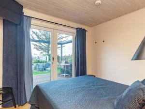 a bedroom with a bed and a sliding glass door at Beachfront Family Retreat - By Traum Ferienwohnungen in Næs