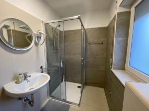 a bathroom with a shower and a sink at Stella Boutique Rooms in Sesvete