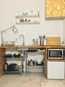 a kitchen with a sink and a microwave at Casa da Travessa in Lisbon