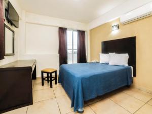 Postel nebo postele na pokoji v ubytování Hotel Puerto Inn