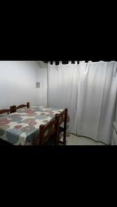 una habitación con una mesa con un edredón en Departamento Estrada en Tandil