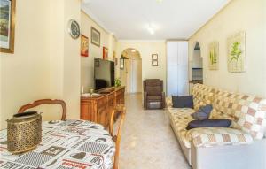 a living room with a couch and a table at Amazing Apartment In Santa Pola in Santa Pola