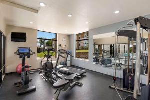 a gym with two treadmills and two ellipticals at SureStay Plus Hotel by Best Western Coralville Iowa City in Coralville
