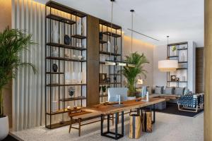 a living room with a table and a couch at Radisson Beach Resort Palm Jumeirah in Dubai