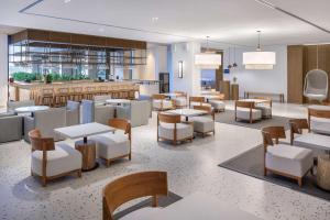 a restaurant with tables and chairs and a bar at Radisson Beach Resort Palm Jumeirah in Dubai