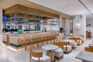 a restaurant with tables and chairs and a bar at Radisson Beach Resort Palm Jumeirah in Dubai