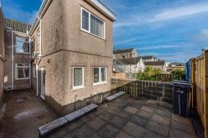 an outside view of a building with a patio at Cheerful 5 bed Property in Llanelli in Llanelli