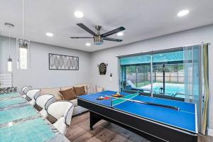 a living room with a pool table in it at Stunning Heated Pool House Close to Tampa in Seffner