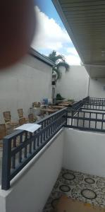a balcony with a table and chairs on a patio at __APlaridel Inn Suites__ in Angeles