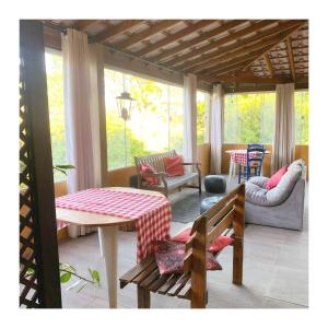 un porche cubierto con mesa y sillas en Café com Morada - Cama e Café en Jundiaí