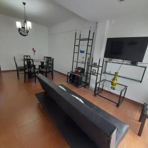 a living room with a couch and a flat screen tv at Alquiler temporario 3 amb Parque Luro Mar del Plata in Mar del Plata +4 photos
