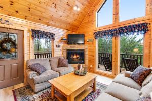 a living room with couches and a fireplace in a cabin at Grizzly Manor in Pigeon Forge