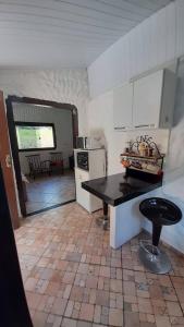 a kitchen with a table and a stove in it at Sossego Da Mata in Santo Antônio do Leite