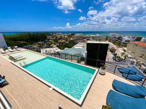 a swimming pool with a view of the ocean at Beautiful + Luxury + Ocean View + Pool in Playa del Carmen