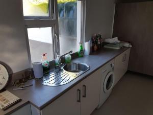 a kitchen counter with a sink and a window at Sunnyside Lodge - Beautiful Fermanagh Holiday Home 