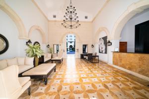 a living room with a couch and a chandelier at The Regent Grand in Grace Bay